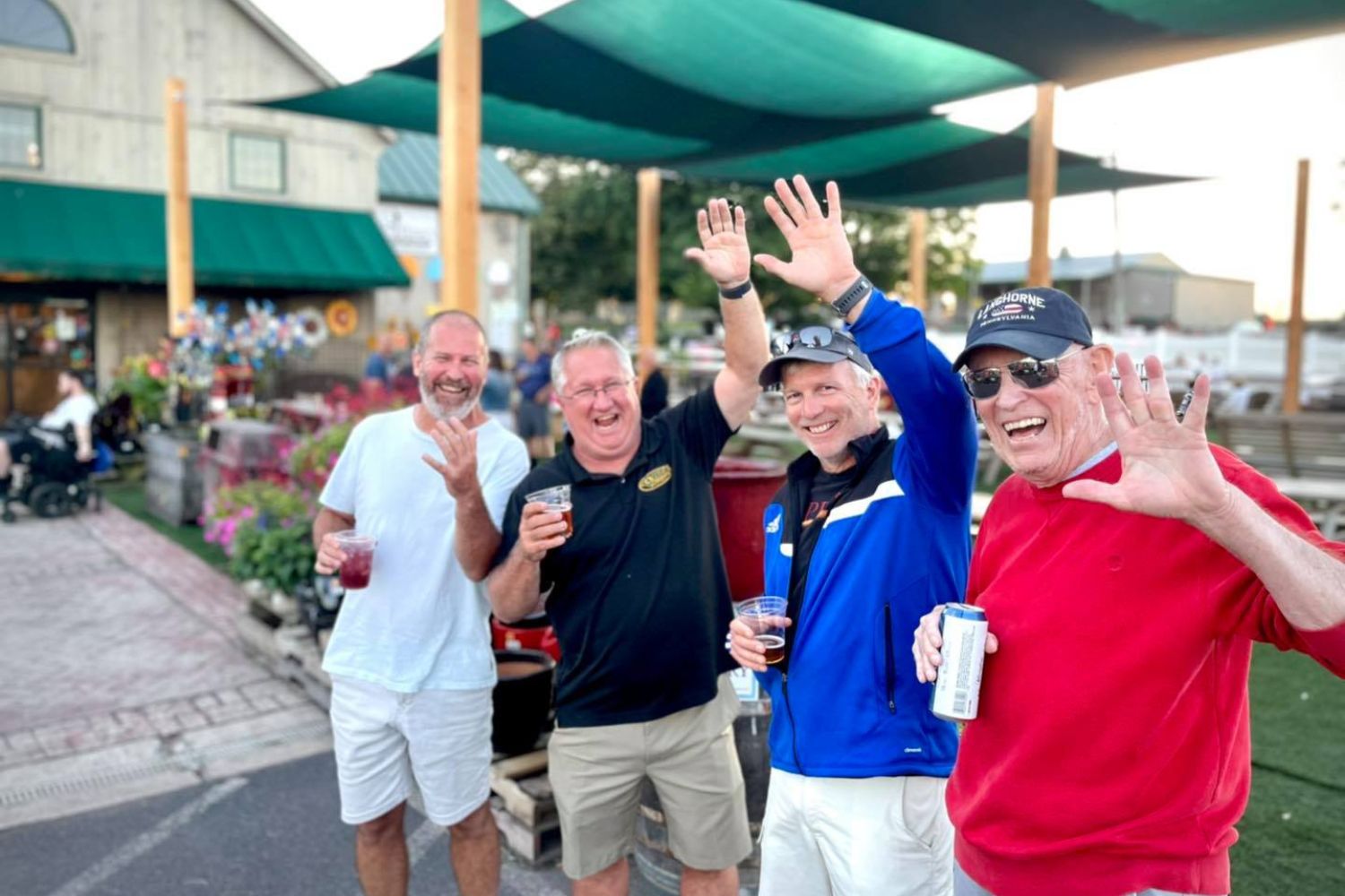 guys waving at the farm market